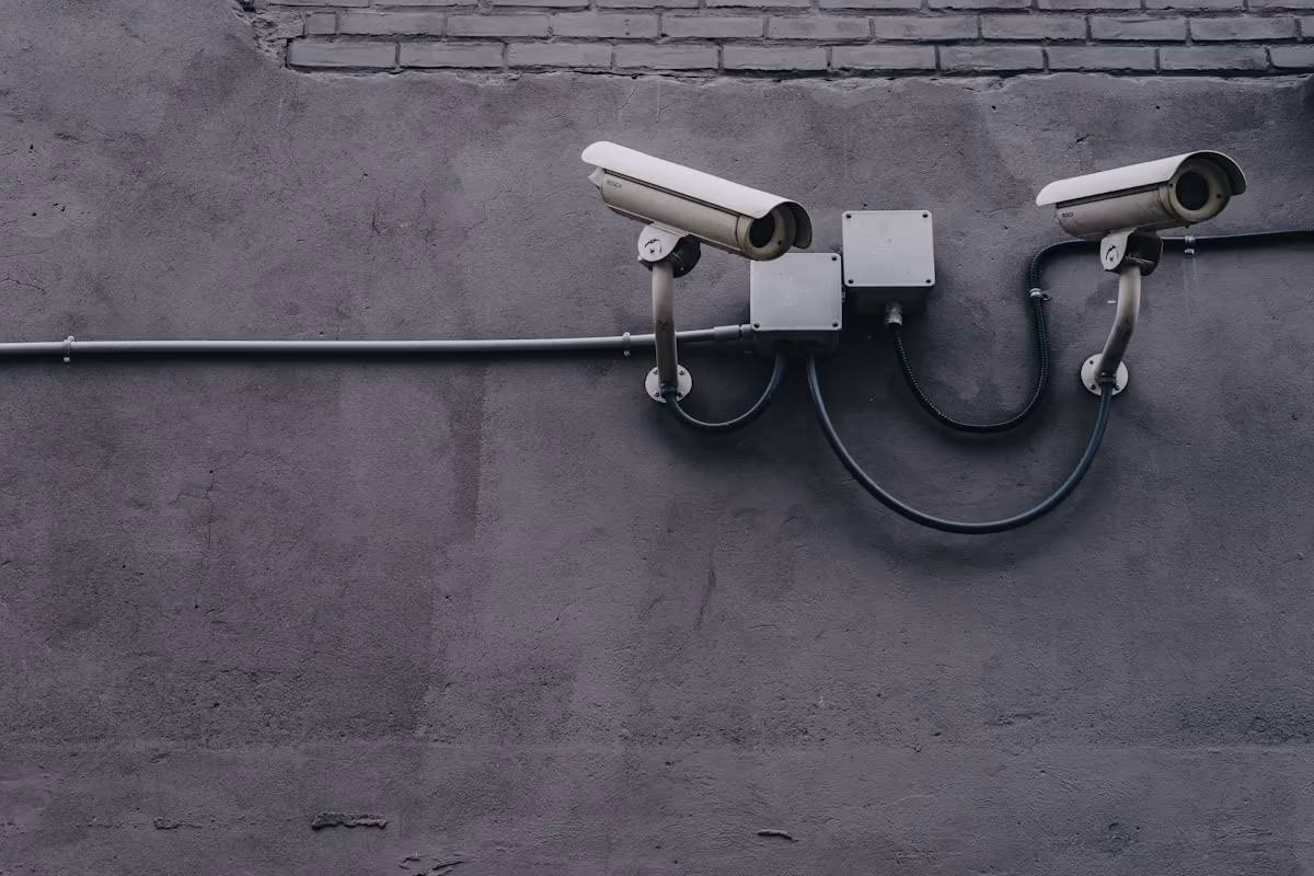 Twin bullet IP surveillance cameras mounted on a wall